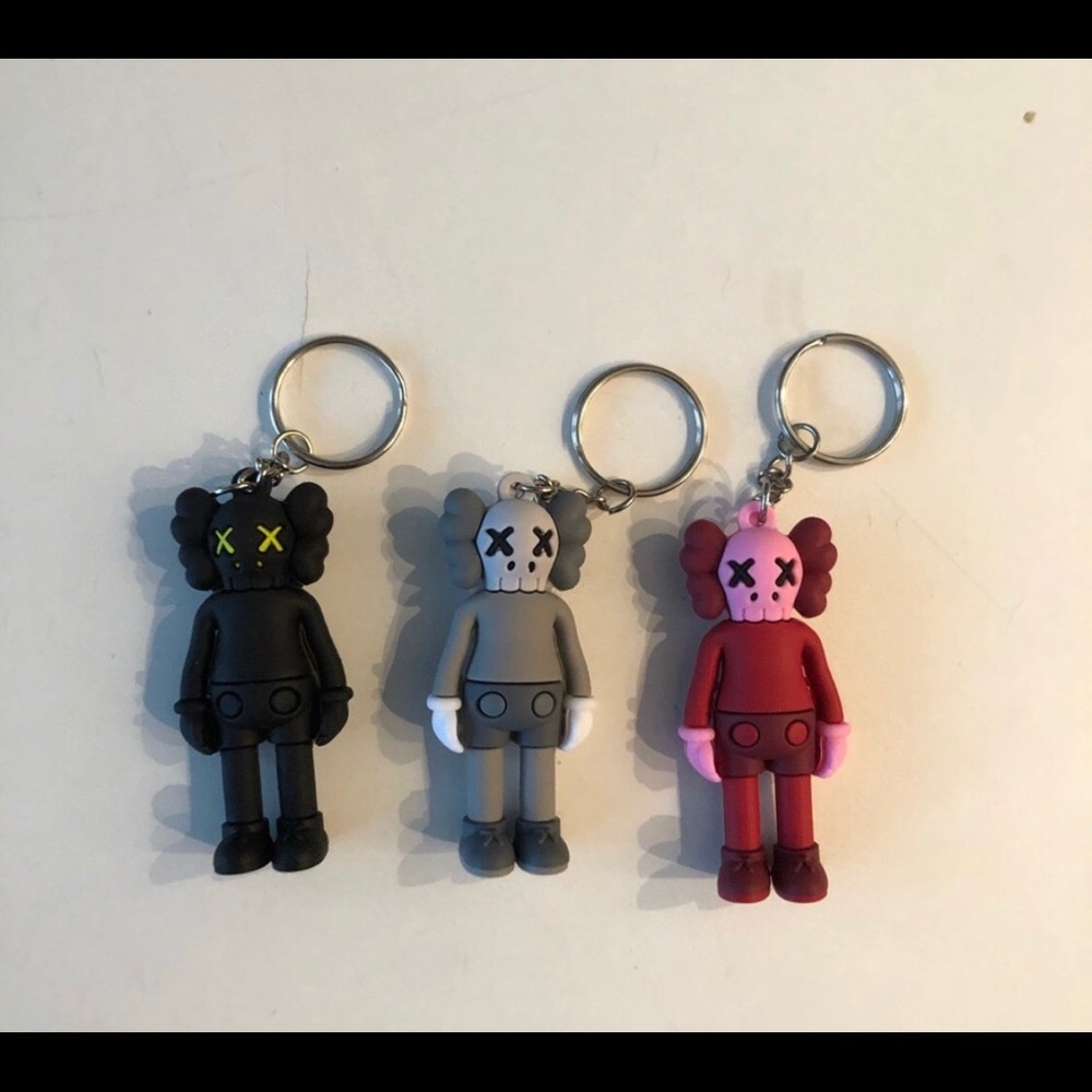3 Kaws keychains with boxes